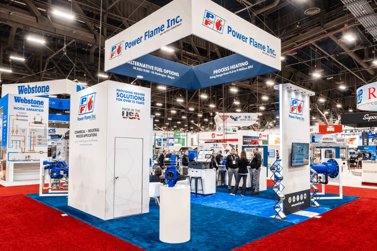A large custom trade show exhibit surrounded by attendees